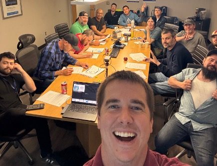 Shem Hatfield with a group of workshop participants around a conference table in Port Murray, New Jersey