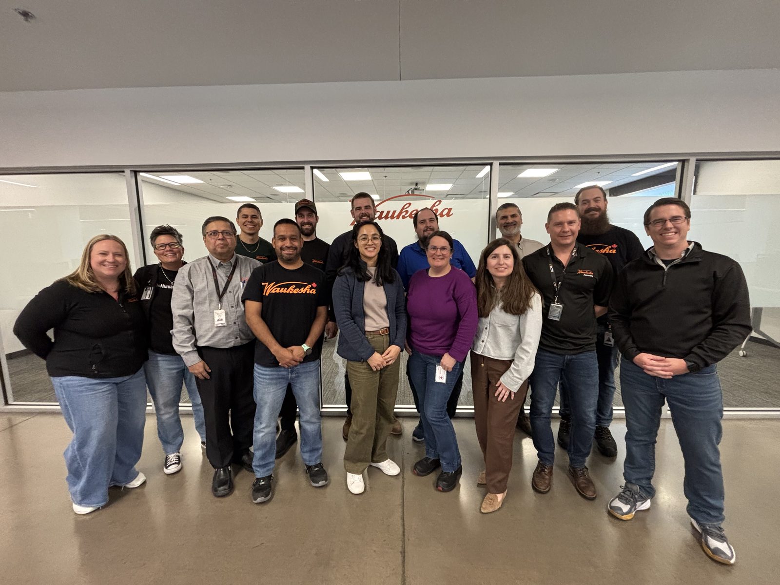 Shem Hatfield with a group of employees at a manufacturing facility in Welland, Canada