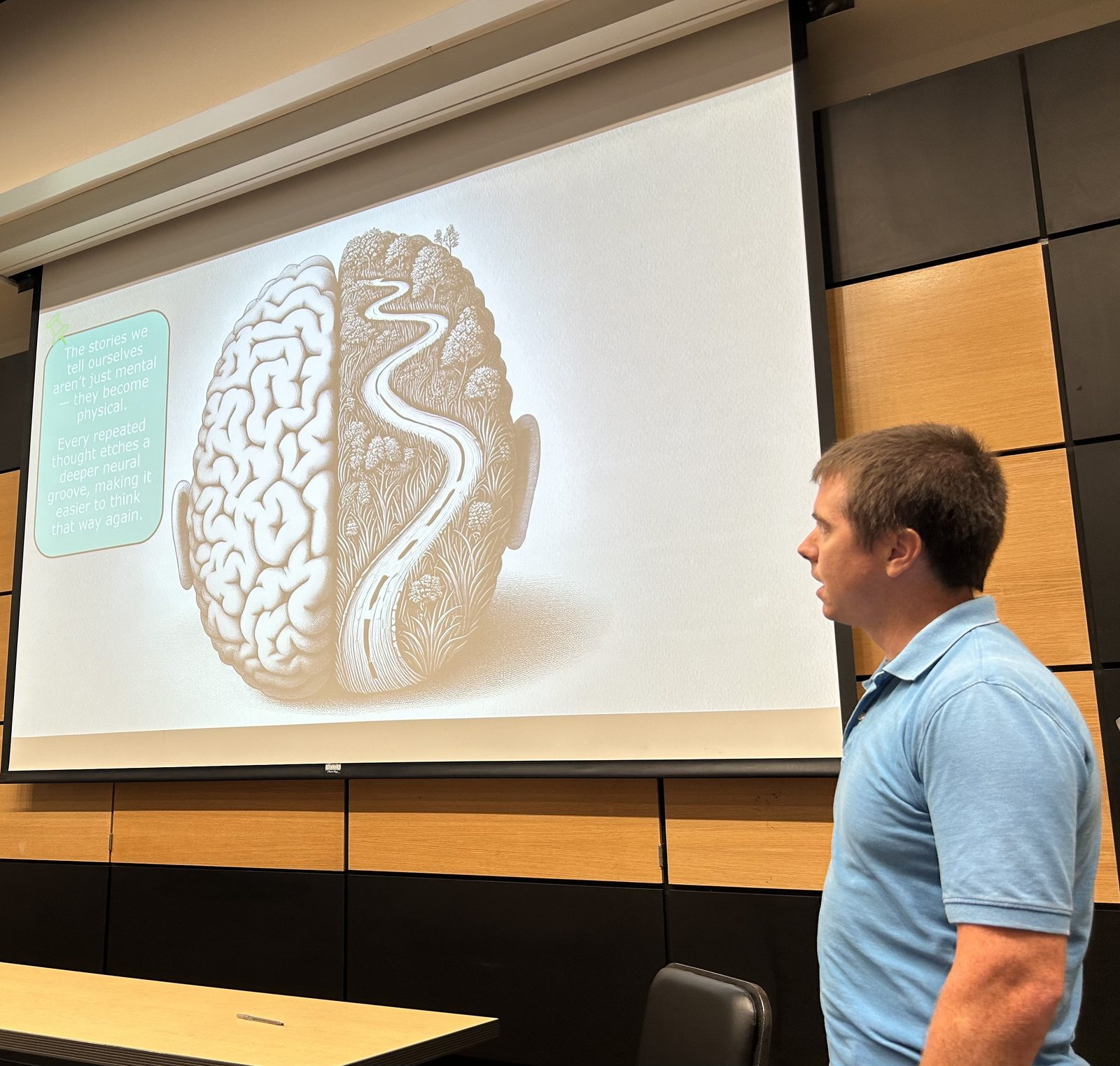 Shem Hatfield leading a training session in Wichita, Kansas, reviewing a slide on how repeated thought patterns shape behavior