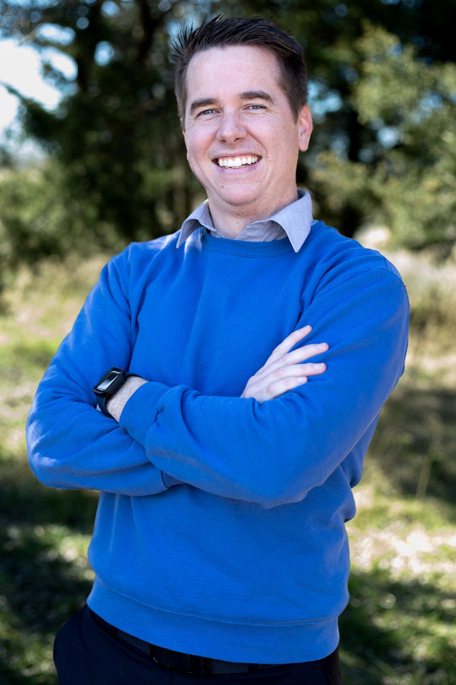 Shem Hatfield, founder of Wired Human, smiling with arms crossed outdoors